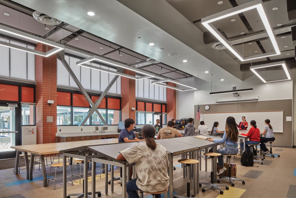 The design team incorporated biophilic principles into the modernization of Grover Cleveland High School, using vision glazing in select wall panels to balance light control with clear outdoor views. Photo: Kingspan Light + Air; Benny Chan/Fotoworks