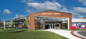 The Hub for Innovators, Veterans and Entrepreneurs (HIVE) breathes new life into Winchester’s historic 1940 armory, transforming the former National Guard training site and community gathering place into a dynamic center for learning and service. After stabilizing and restoring the 18,000-square-foot structure with careful masonry repair, new roofing, and historically sensitive windows, the design team reimagined the gymnasium as a suite of cutting-edge incubator and academic spaces, including immersive learning labs, maker areas and a mezzanine connected to the E-Sports arena. The adjacent armory is being repurposed as a dedicated Veterans Center offering counseling, employment support and community resources. A striking new glass addition, the Collaboratory, complements the historic architecture while housing the Shenandoah Center for Immersive Learning (SCiL) and providing flexible event space. Blending preservation with innovation, the HIVE honors its military heritage while supporting Shenandoah University’s evolving academic vision. Photo: Eric Laignel
