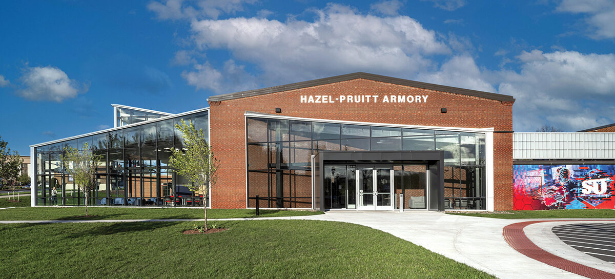 The Hub for Innovators, Veterans and Entrepreneurs (HIVE) breathes new life into Winchester’s historic 1940 armory, transforming the former National Guard training site and community gathering place into a dynamic center for learning and service. After stabilizing and restoring the 18,000-square-foot structure with careful masonry repair, new roofing, and historically sensitive windows, the design team reimagined the gymnasium as a suite of cutting-edge incubator and academic spaces, including immersive learning labs, maker areas and a mezzanine connected to the E-Sports arena. The adjacent armory is being repurposed as a dedicated Veterans Center offering counseling, employment support and community resources. A striking new glass addition, the Collaboratory, complements the historic architecture while housing the Shenandoah Center for Immersive Learning (SCiL) and providing flexible event space. Blending preservation with innovation, the HIVE honors its military heritage while supporting Shenandoah University’s evolving academic vision. Photo: Eric Laignel