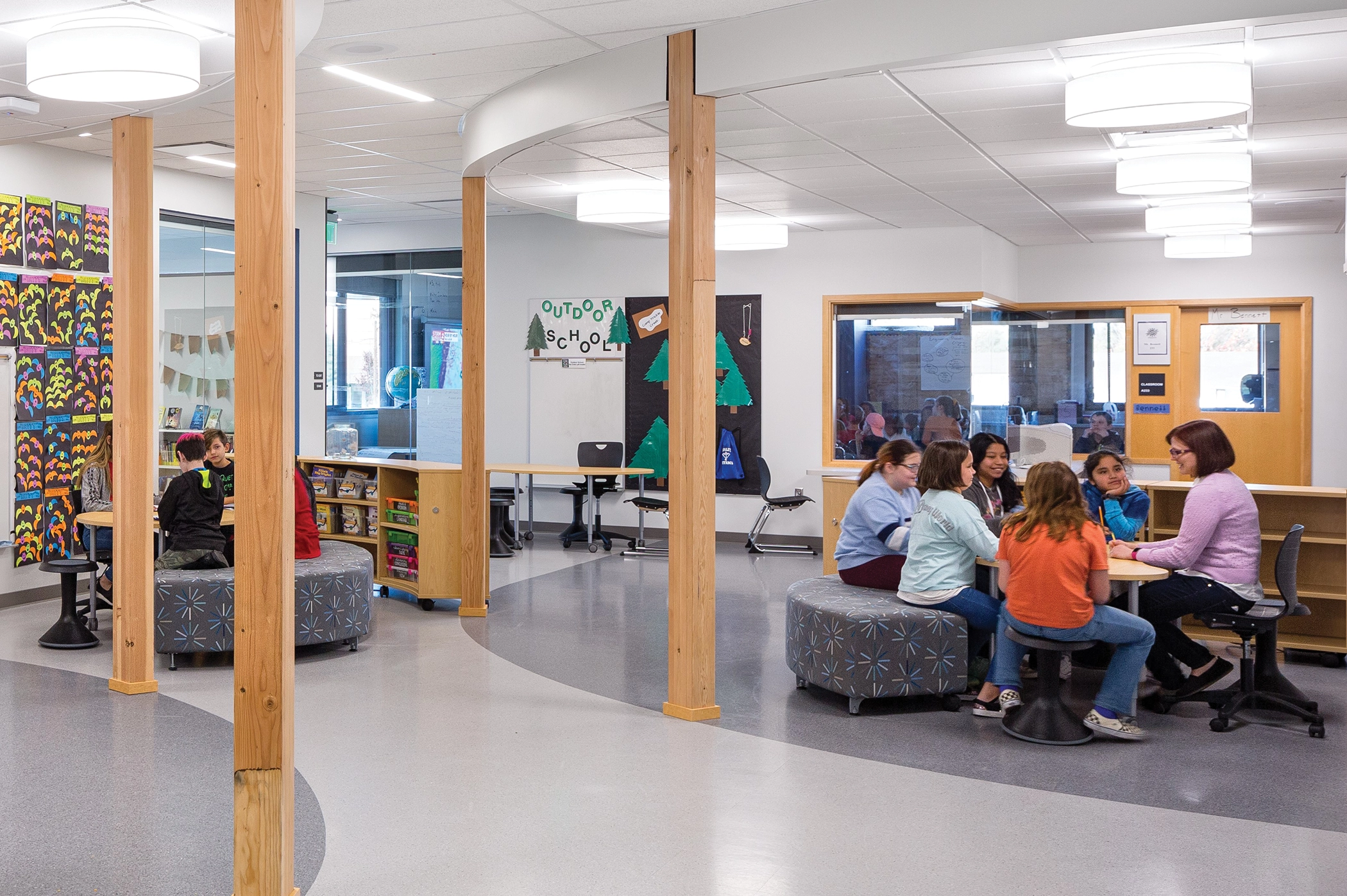 Templeton Elementary School, Tigard, Oregon. A specialist works closely with a group of students in a shared extended learning area adjacent to classrooms. Photo: Josh Partee