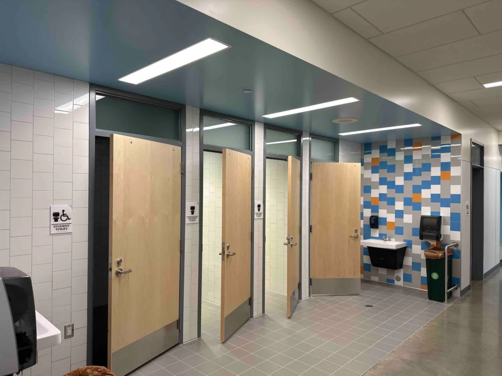 Single-user elementary restroom open to hallway for ease of access and maximum supervision. Designed by NAC at James Baldwin ES, Seattle Public Schools. Photo: © Benjamin Benschneider